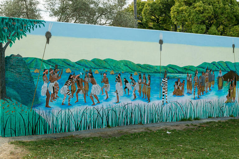 Mural honoring the Ohlone people depicts the Ohlone creation story, the Ohlones preparing to greet European visitors, ancestors of the Ohlones, and living descendents.