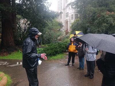 Students listen to Tim Pine give a creek tour on a rainy day